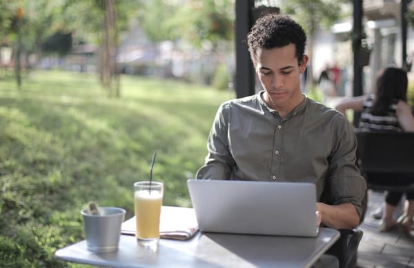 Freelancer working on laptop at a street cafe in Colombia